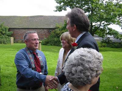 Mike being congratulated by Harry.