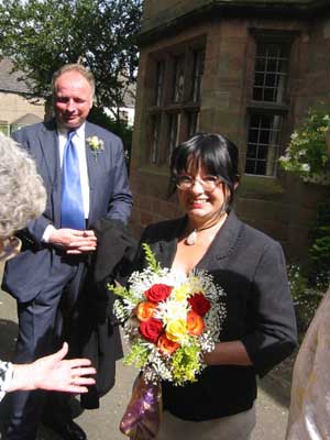 Jennie, bridesmaid with flowers, and Dan.