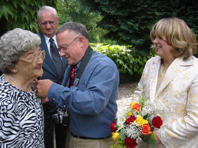 Harry pins Margart's corsage.