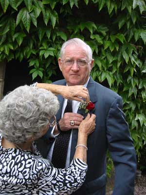 Margaret pins Tom's boutonni&egrave;re